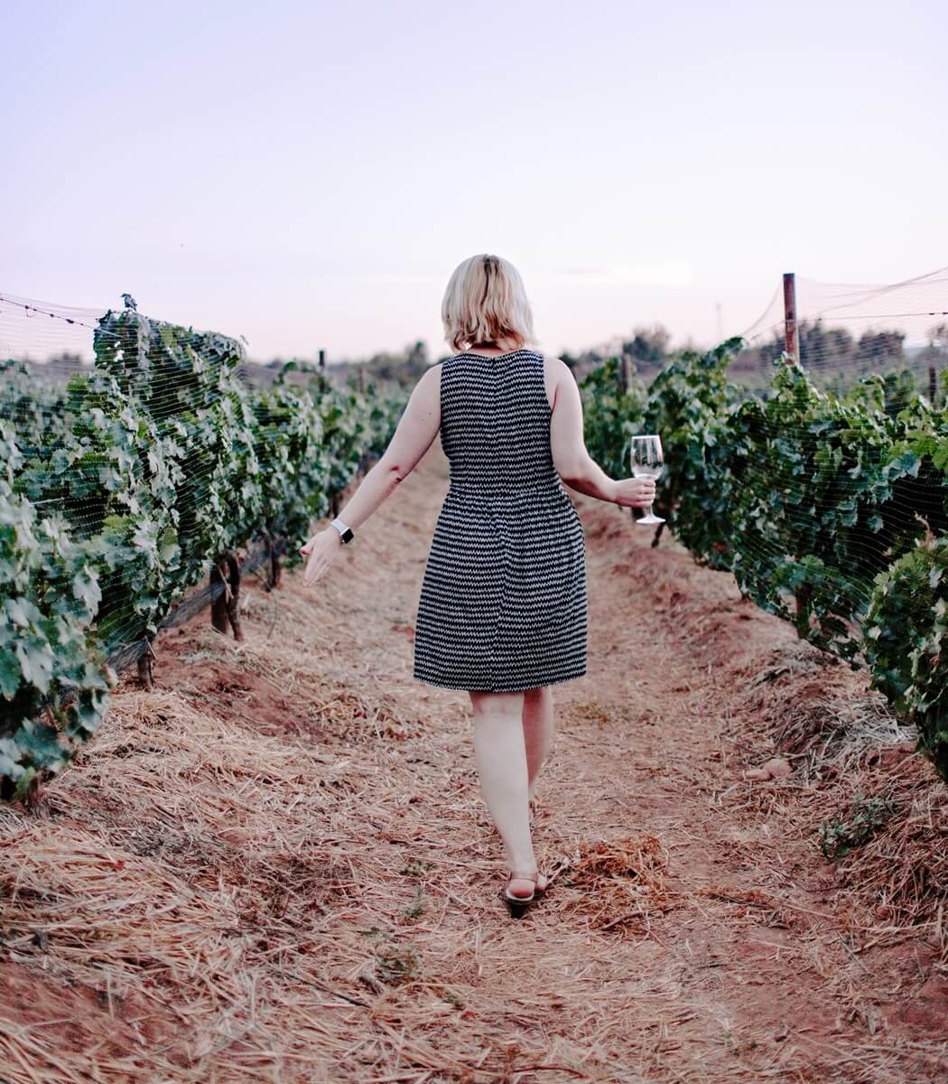 Touring a Napa Valley vineyard, with a glass of Gewürztraminer