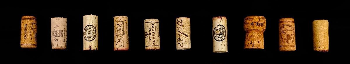 A row of champagne corks on a black background